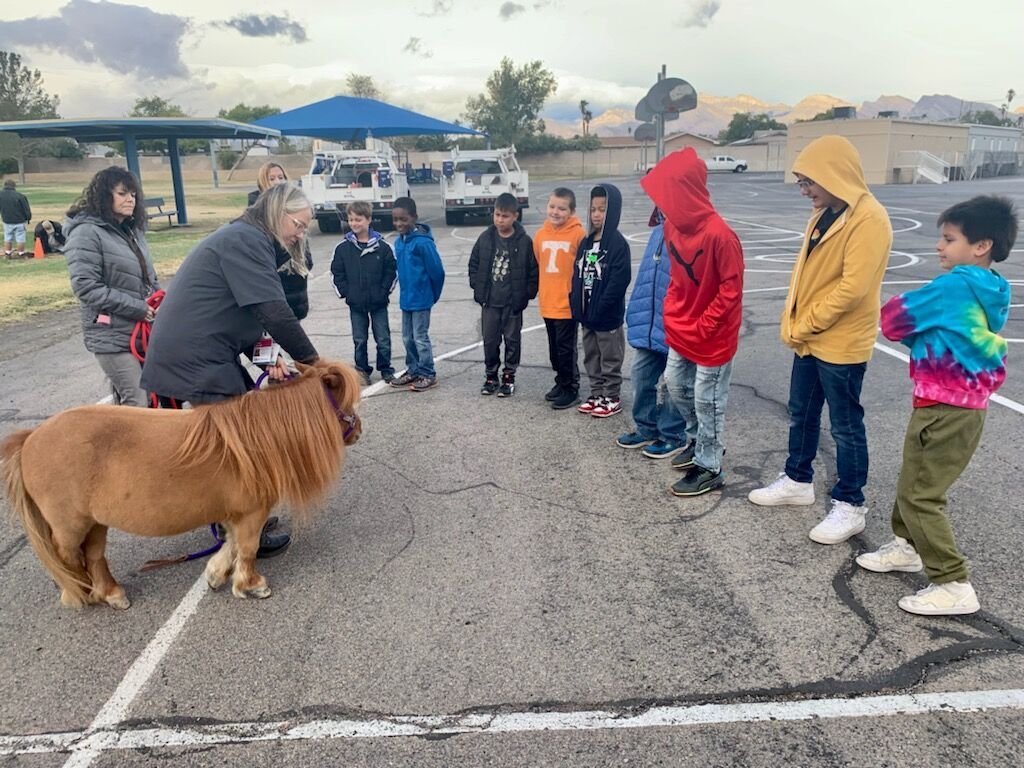 Scarlet meeting a line of students outside a school